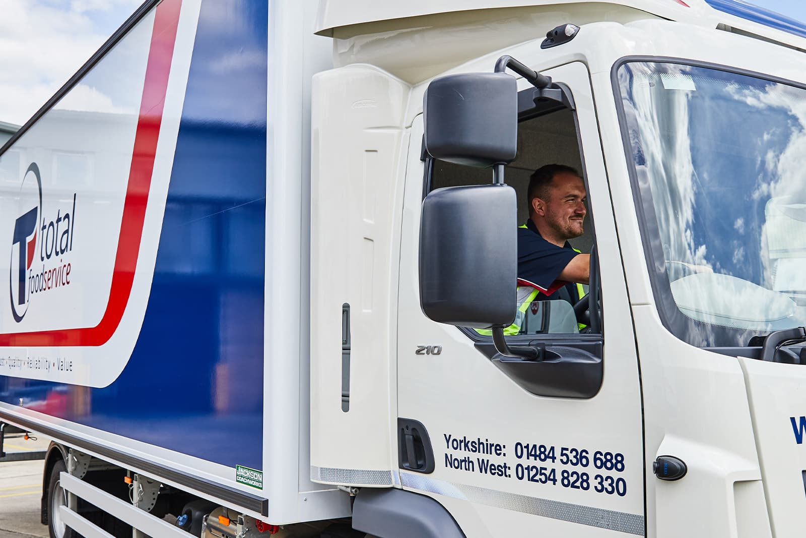Total Foodservice driver in the cab of a delivery lorry