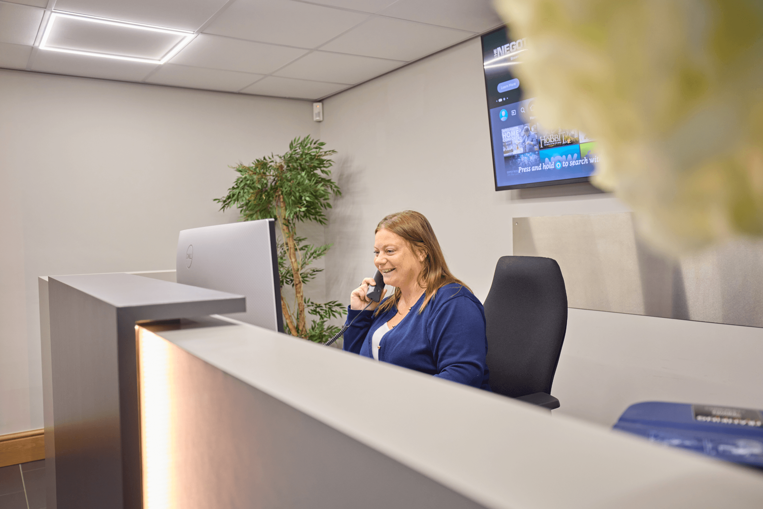 Receptionist on the phone at the Total Foodservice front desk