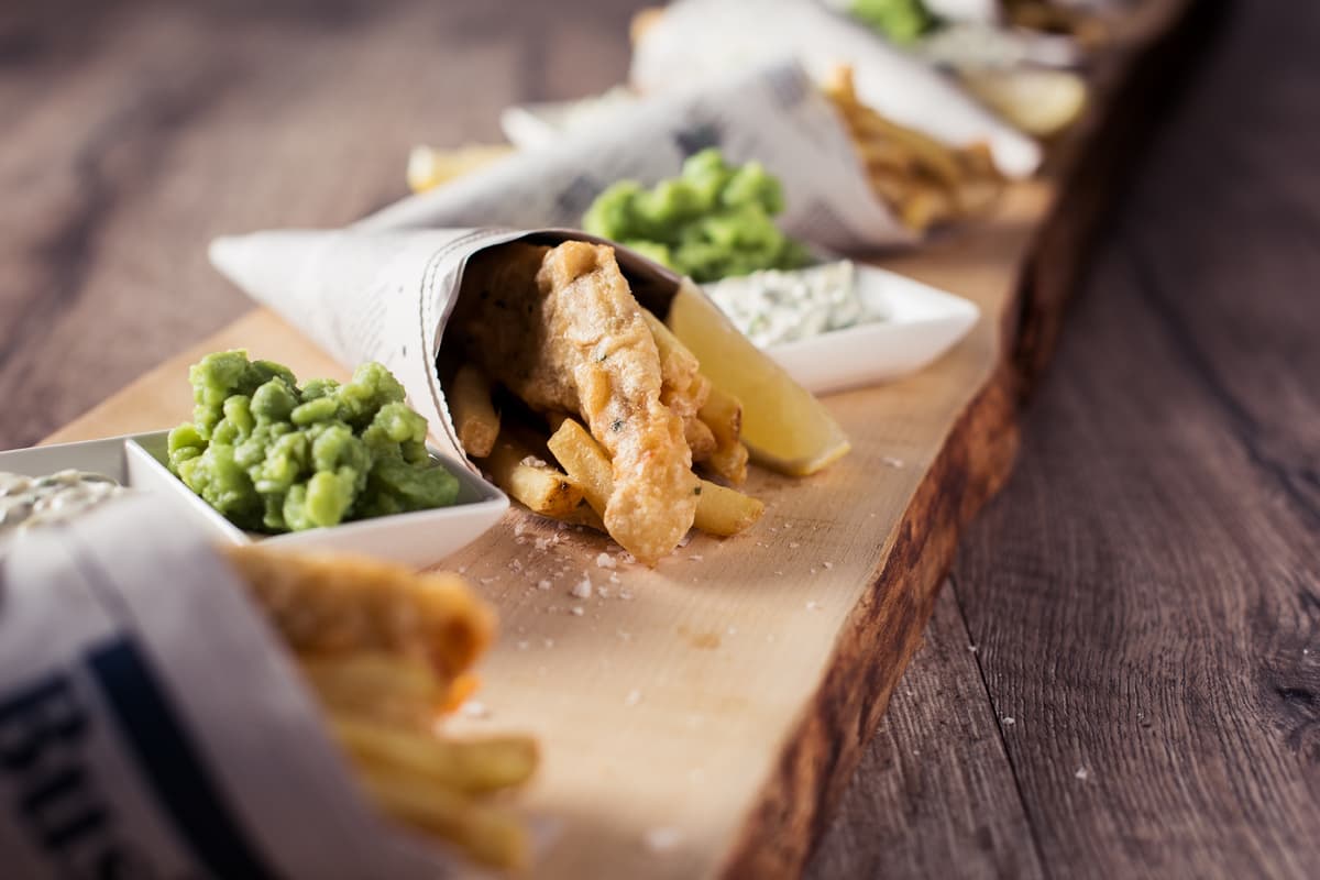 Fish and chips in paper cones with mushy peas