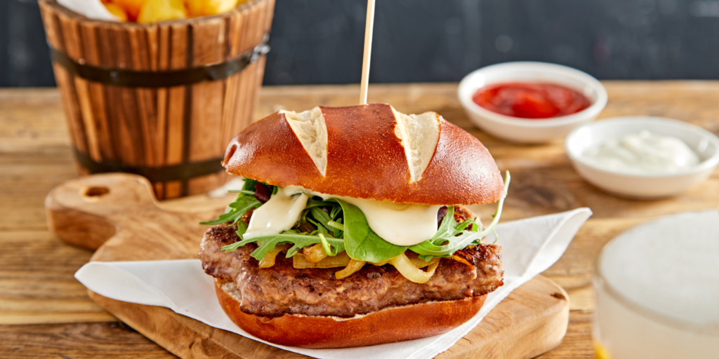 Burger with sauteed onion, rocket and Beer cheese
